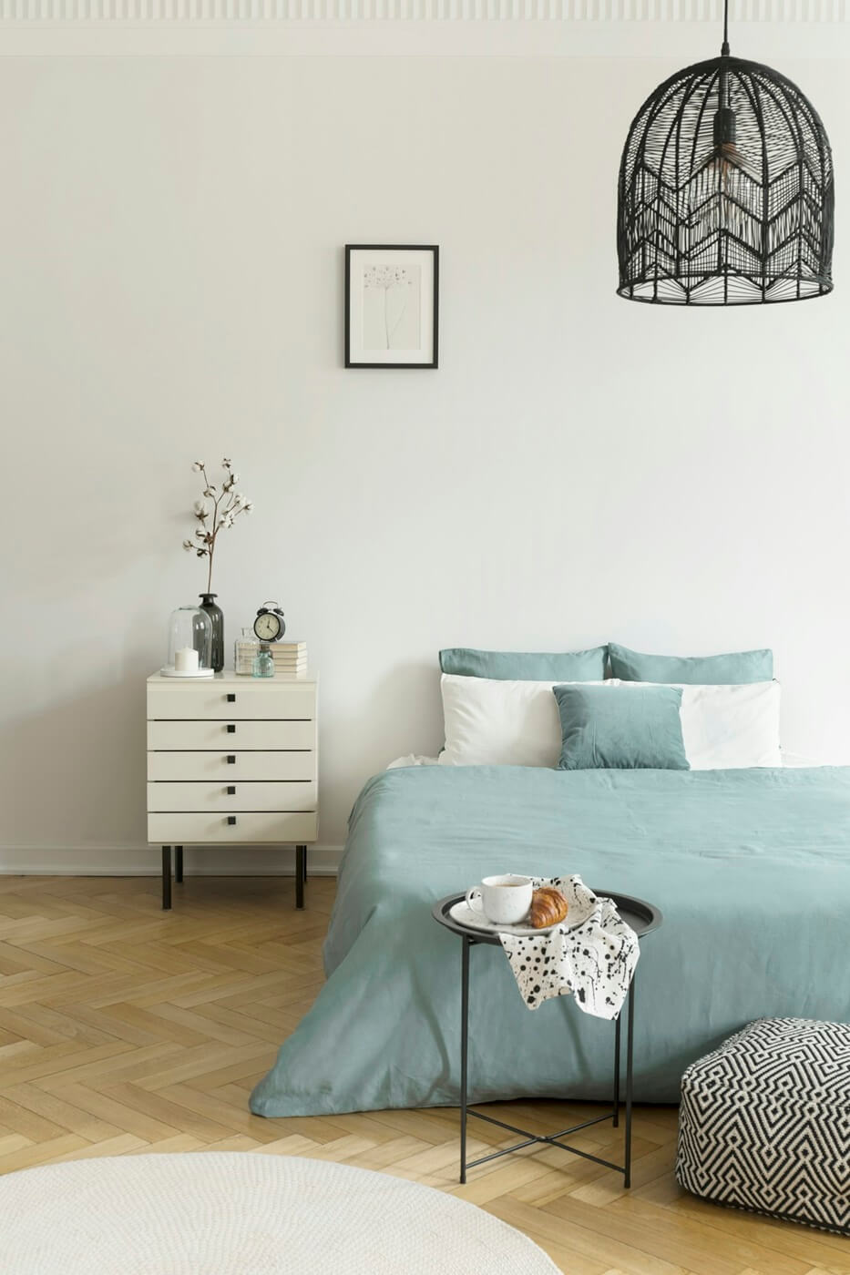 breakfast-on-a-metal-table-in-front-of-a-bed-with-sage-green-bed-U7JE6KD